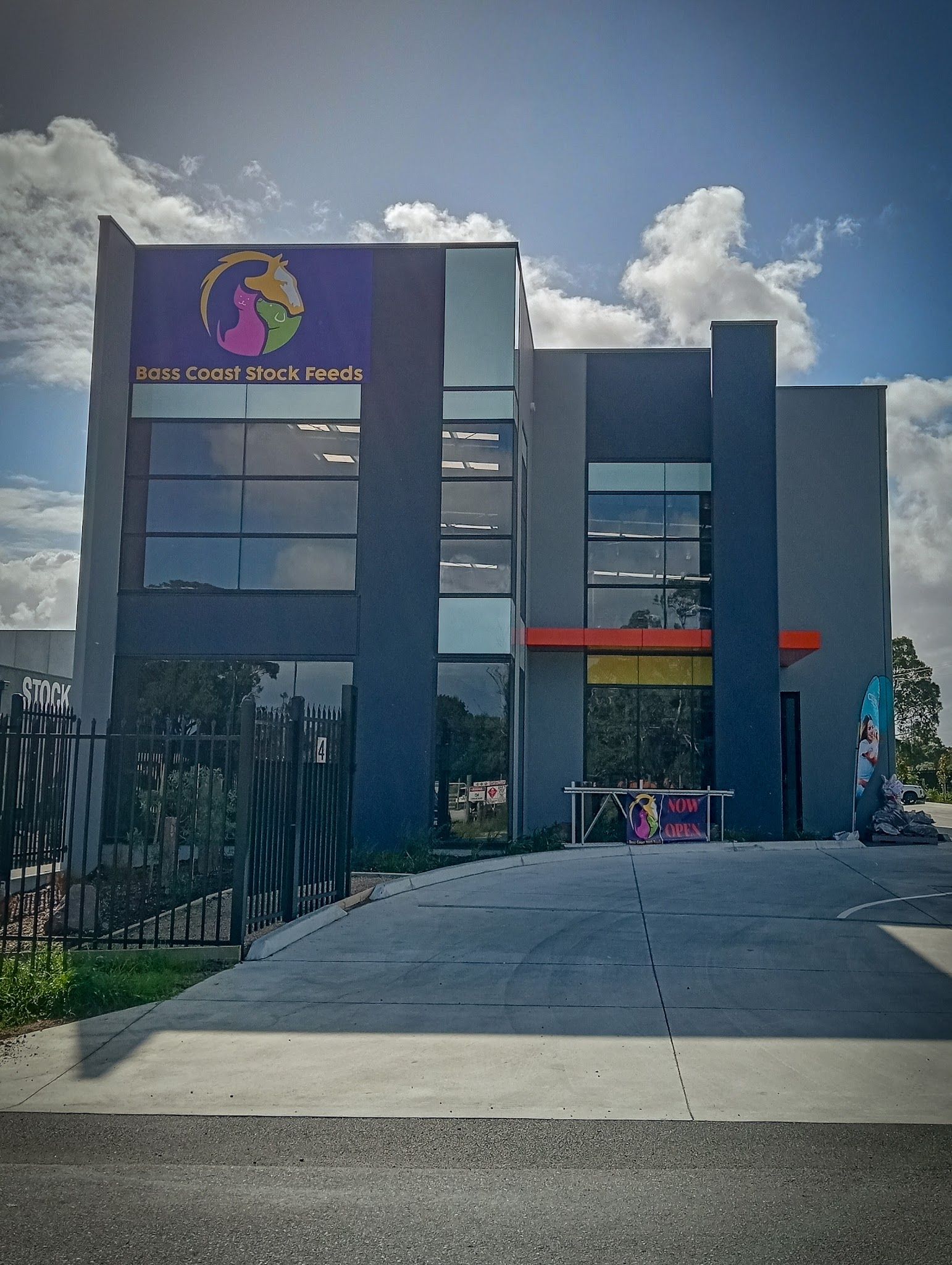 Bass Coast Stock Feeds modern building exterior with logo signage and Now Open banner